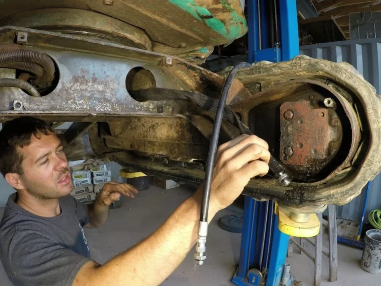 technician checking excavator final drive